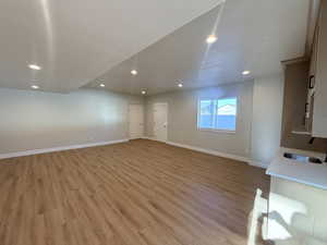 Unfurnished living room with light wood finished floors and recessed lighting