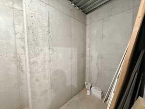 Bathroom featuring concrete floors and a shower