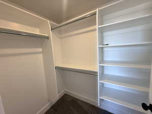 Walk in closet with dark carpet