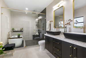 Master Bathroom with double vanity, a large 2 head shower, a soaking tub, and gorgeous tile throughout.