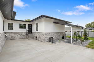 Private patio on the North side of home for entertaining or just as a private retreat. Also showing the basement entrance.