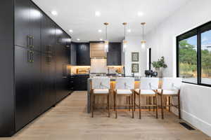 Kitchen has tons of storage along with high end appliances, and a breakfast bar seating 4.