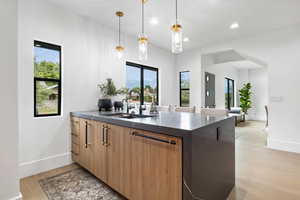 Kitchen with a peninsula, with dishwasher, pendant lighting, filtered water, separate icemaker, and 4-seat breakfast bar.