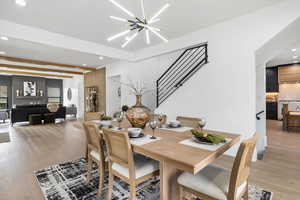 Dining room with gorgeaous lighting, engineered wood flooring, and lots of natural lighting.