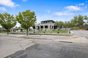 View of front facade featuring a brand new metal and asphalt shingle roof.