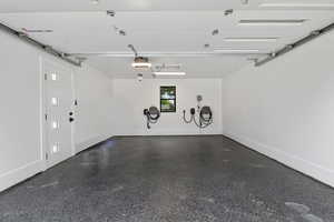 Garage with baseboards, finished floor and 2 EV chargers.