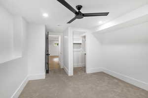 NW basement Bedroom room with a walk-in closet, a ceiling fan, and lots of natural lighting.