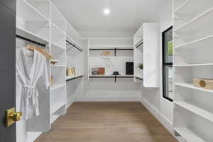 Spacious Master bedroom closet with engineered hard wood flooring.