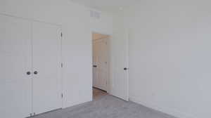 Unfurnished bedroom with carpet floors and a closet