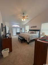 Carpeted bedroom with lofted ceiling, a ceiling fan, and access to exterior