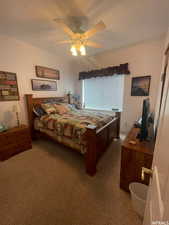 Bedroom with light colored carpet and ceiling fan