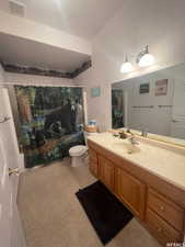 Bathroom with a textured wall, vanity, and shower / bath combo