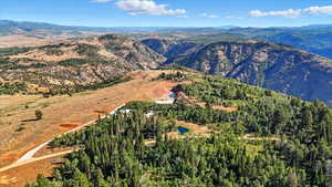 Aerial overview of property's location featuring a mountainous background