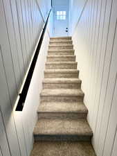 Stairway has custom railing with automated motion sensor lighting