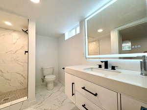 Downstairs bath with beautiful tile work, floating vanity and self-defogging mirror