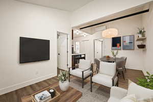 Living room featuring wood finished floors and a wall mounted air conditioner