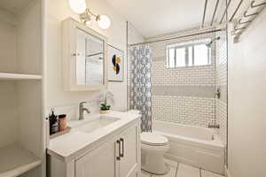 Full bathroom featuring shower / bathtub combination with curtain, vanity, and tile patterned floors