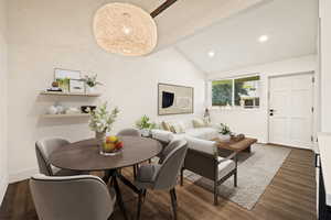 Dining area with dark wood-type flooring, high vaulted ceiling, and recessed lighting