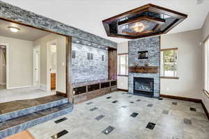 Beautifully finished Custom Great room featuring beautiful Cherry Wood Ceiling frame feature with lighting, Custom tile floor, and lighted Custom wood framed space that the seller used to display a 3 piece art pictures.