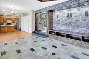 Great room off of Kitchen. Custom built space with LED remote control lights.  Seller had a beautiful picture in the custom framed space and would use the remote controls to change the color on the installed Lighting.  He would put nice glass figures, cry