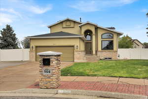View of front of property featuring driveway to garage and RV parking.  Mailbox is custom built with lighting to illuminate the house number and box opening.  Also solid granite top.  Mailbox also locks with a key.