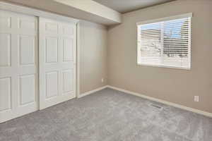 Main Level Bedroom with Spacious Closet. It is situated next to a separate Full Bathroom.
