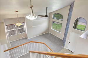 View of Foyer entrance to formal living room with new  with new carpet, high vaulted ceilings.