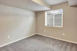 Carpeted empty room 1of 2 bedrooms in the basement