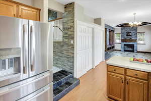 Kitchen with new stainless steel fridge off of possible formal dining room, and off of great room.