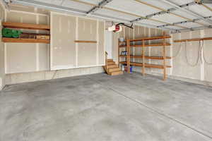 2 Car Garage featuring a garage door opener, built in shelving