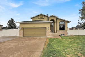 View of front of house which is stucco and brick that is in excellent condition.  Front grass and automatic sprinklers.