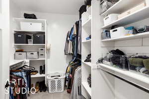 Walk in closet featuring light colored carpet