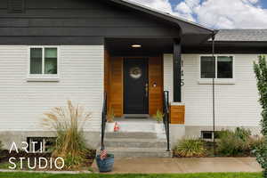Doorway to property with brick siding