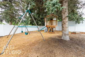 View of play area featuring a fenced backyard