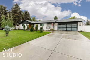View of front facade featuring concrete driveway and an attached garage