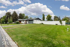 View of yard with concrete driveway and an attached garage
