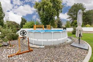 View of swimming pool featuring a fenced backyard