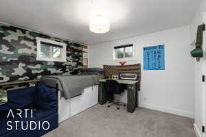 Office space with light carpet and a textured ceiling