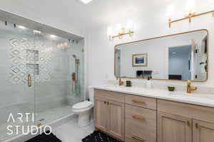 Full bathroom featuring double vanity, a shower stall, and tile patterned flooring