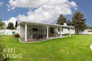 Rear view of property featuring a chimney and a patio