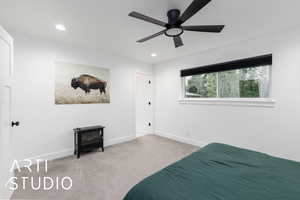 Carpeted bedroom featuring a wood stove, recessed lighting, and ceiling fan