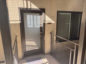 View of exterior entry featuring stucco siding