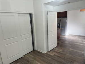 Hall with dark wood-style flooring