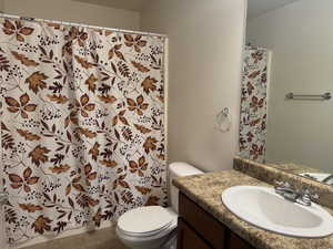 Bathroom with a shower with shower curtain, vanity, and tile patterned floors