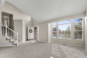 Carpeted living room with bright windows all new carpet and 3-tone paint.