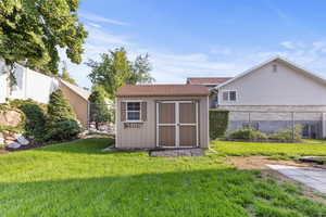 View of shed with a fenced backyard