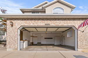 Garage with opener, side door, window and bench.