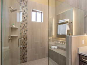 Full bathroom featuring a stall shower and vanity