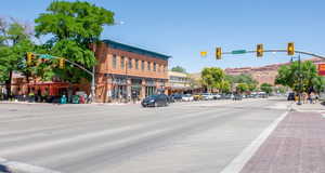 View of asphalt street featuring traffic lights, sidewalks, street lights, and curbs