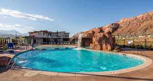 Community pool featuring a mountain view, a patio, a balcony, and a jacuzzi